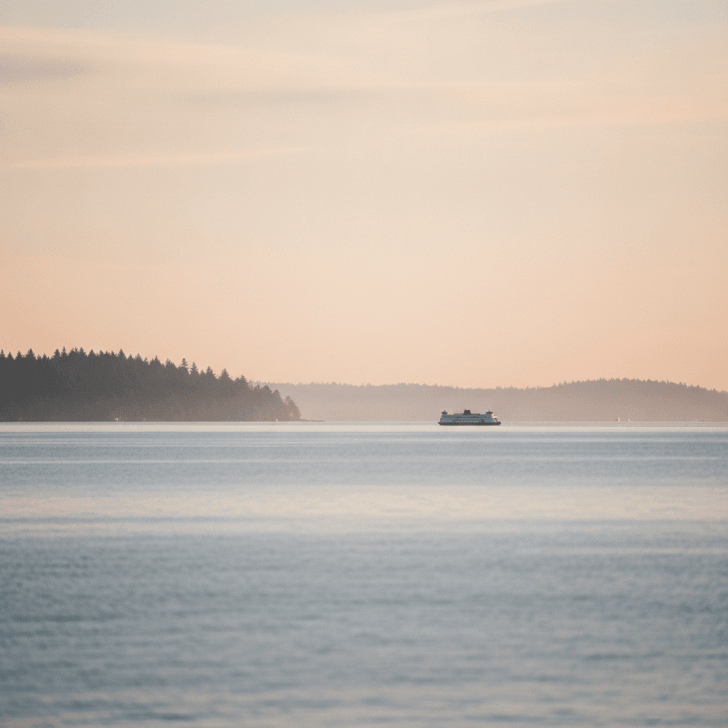 Soft-focus Puget Sound with a Washington State Ferry silhouette in golden-hour mist